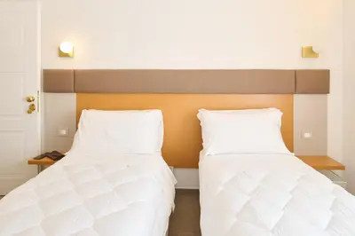 Letto o letti in una camera di San Nicola Rooms Siracusa