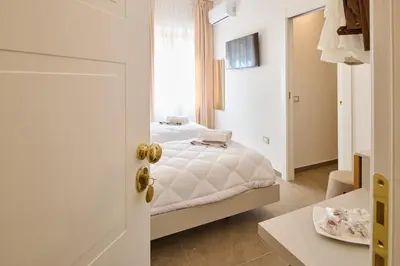Letto o letti in una camera di San Nicola Rooms Siracusa