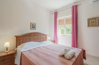 Letto o letti in una camera di Villa Valentina casa vacanze fontane Bianche