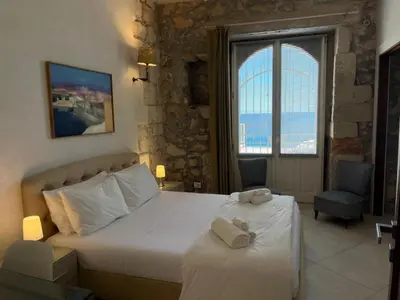Letto o letti in una camera di Casa Calarossa Ortigia
