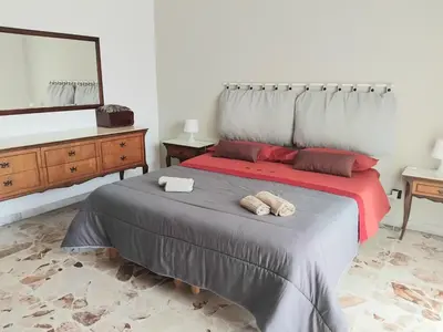 Letto o letti in una camera di VITTORIA APARTMENT 4 posti letto parcheggio libero