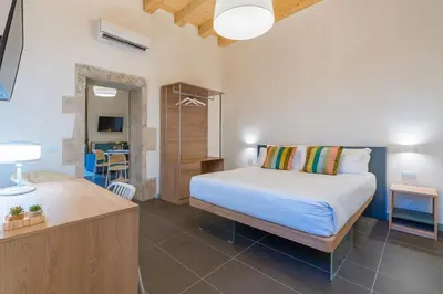 Letto o letti in una camera di La Dimora di San Nicola Ortigia Boutique Apartments - Terrace & Jacuzzi Access