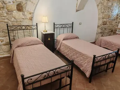 Letto o letti in una camera di Ortigia Levante