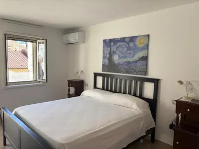 Letto o letti in una camera di Domus Poseidone