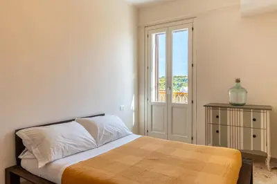 Letto o letti in una camera di Casa Verga con Terrazza by Wonderful Italy
