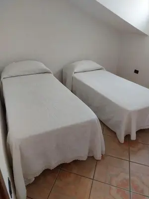 Letto o letti in una camera di Casa Sara