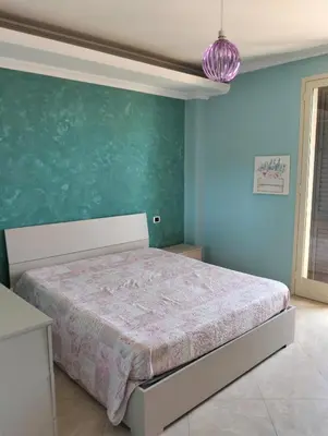 Letto o letti in una camera di Appartamento Angela