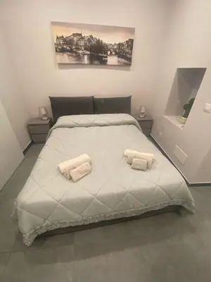 Letto o letti in una camera di Casa Ortensia - Appartamento Moderno in Centro