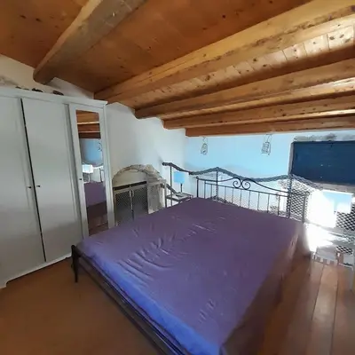Letto o letti in una camera di IL NIDO, Calamosche