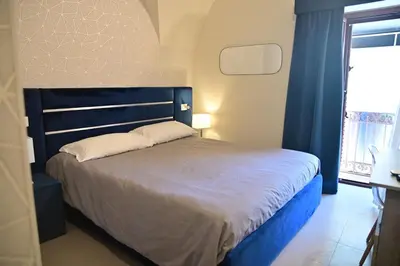 Letto o letti in una camera di B&B del Porto Catania