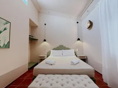Letto o letti in una camera di PalazzoRusso Ortigia Suite & Apartments