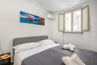 Letto o letti in una camera di GuestHost - Storie di Lava e l'Angolo dell'Elefante Apartments