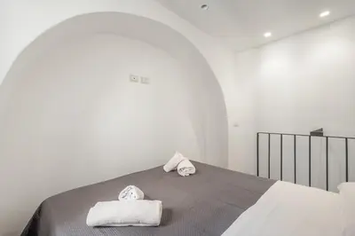 Letto o letti in una camera di GuestHost - Storie di Lava e l'Angolo dell'Elefante Apartments