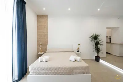 Letto o letti in una camera di Nymphē Ortigia Apartments