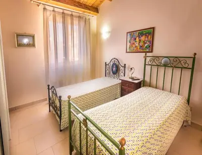 Letto o letti in una camera di Casa Giò, Casa Vacanze Avola