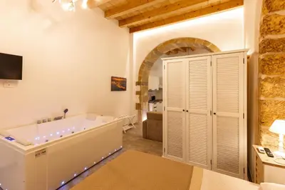 Letto o letti in una camera di La Corte e il Dammuso