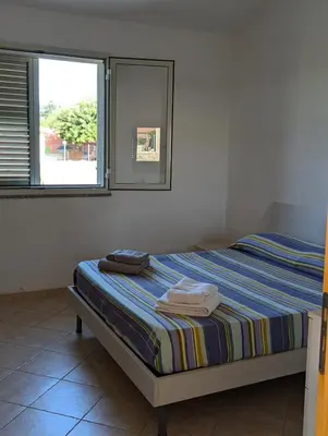 Letto o letti in una camera di Casa Gelsomini