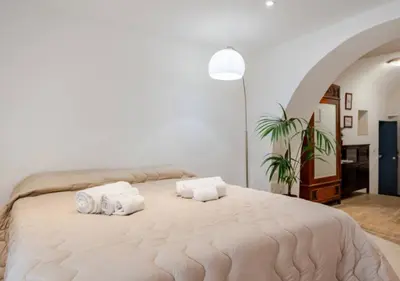 Letto o letti in una camera di Spazio apartments Etnea