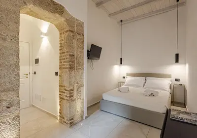 Letto o letti in una camera di Dione Deluxe Rooms Ortigia