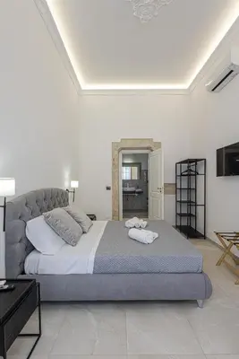 Letto o letti in una camera di Dione Deluxe Rooms Ortigia