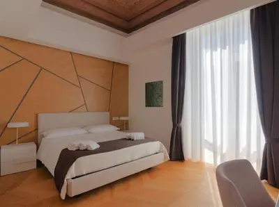 Letto o letti in una camera di L'Arte dell'Eleganza