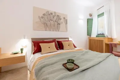 Letto o letti in una camera di Vico Trigona con terrazza e jacuzzi riscaldata