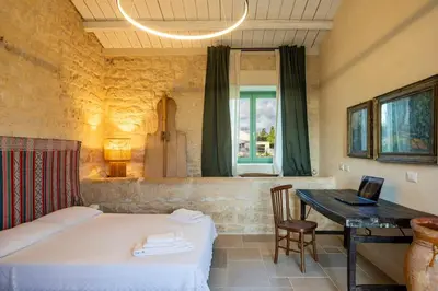 Letto o letti in una camera di Casa Gna Razia - IsulaTravel
