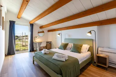 Letto o letti in una camera di Villa Colombo - IsulaTravel