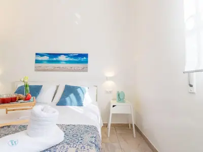 Letto o letti in una camera di Apartment Edoné- Wohnung mit Blick auf einen Sandstrand by Interhome