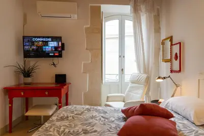 Letto o letti in una camera di GuestHost - Quattro Cuori Ortigia Comfy Studio