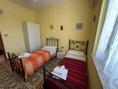 Letto o letti in una camera di Kitiya's House- Di fronte la spiaggia e un mare cristallino