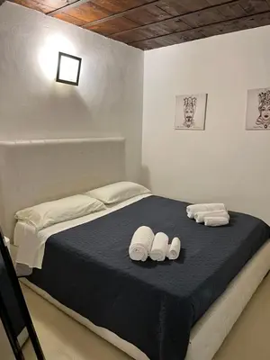 Letto o letti in una camera di le c'Ortigiane di via mergulensi
