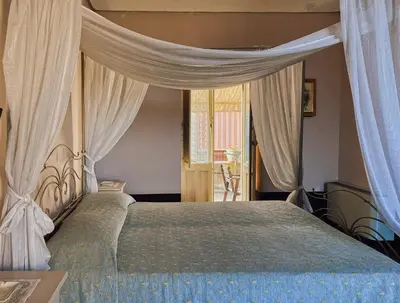 Letto o letti in una camera di Palazzo Gambuzza