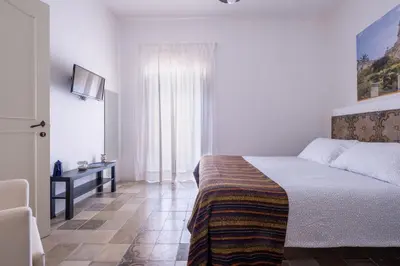 Letto o letti in una camera di SI-Moutique Le Case degli Avi barocche, con terrazza panoramica