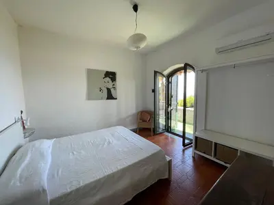 Letto o letti in una camera di Villa Baia del Riccio