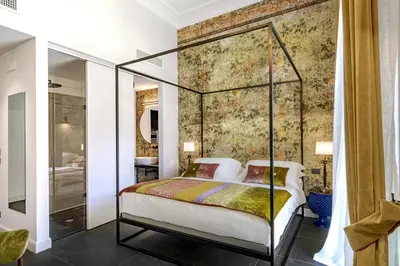 Letto o letti in una camera di Relais Antica Badia - San Maurizio 1619