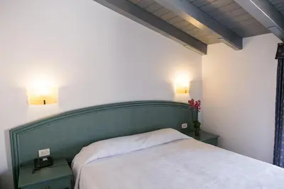 Letto o letti in una camera di Hotel Gran Bretagna Ortigia
