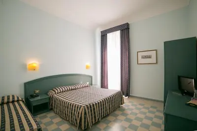 Letto o letti in una camera di Hotel Gran Bretagna Ortigia