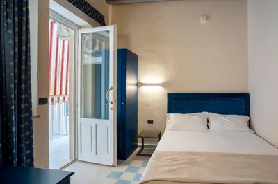 Letto o letti in una camera di Hotel Gran Bretagna Ortigia