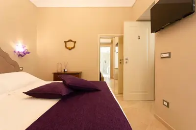 Letto o letti in una camera di Maecò Ortigia B&B - Deluxe Rooms & Suites