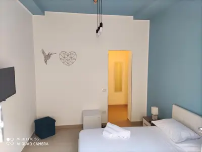 Letto o letti in una camera di iMama' Rooms