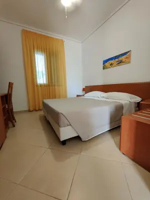 Letto o letti in una camera di Appartamenti in Villa Polimnia
