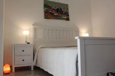 Letto o letti in una camera di Villa Faro Massolivieri