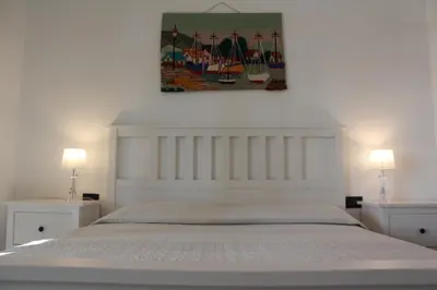 Letto o letti in una camera di Villa Faro Massolivieri