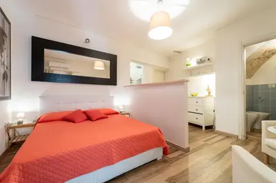 Letto o letti in una camera di GuestHost - Casa Borbonica Cozy Apartment in Ortigia GROUND FLOOR