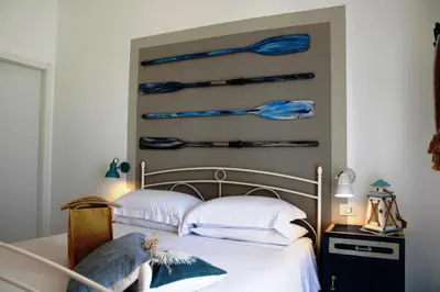 Letto o letti in una camera di B&B Casa del Faro SanVallero Adults Only
