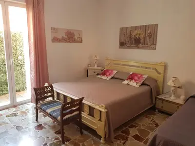 Letto o letti in una camera di B&B CARRUBBELLE