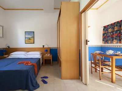 Letto o letti in una camera di Villaggio Albergo Internazionale La Plaja