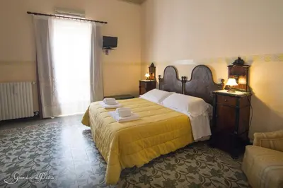 Letto o letti in una camera di B&B Giardino Di Pietra