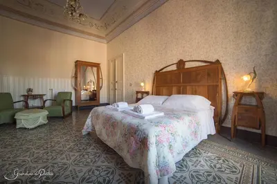Letto o letti in una camera di B&B Giardino Di Pietra